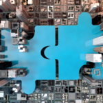 aerial photo of a big blue puzzle between building